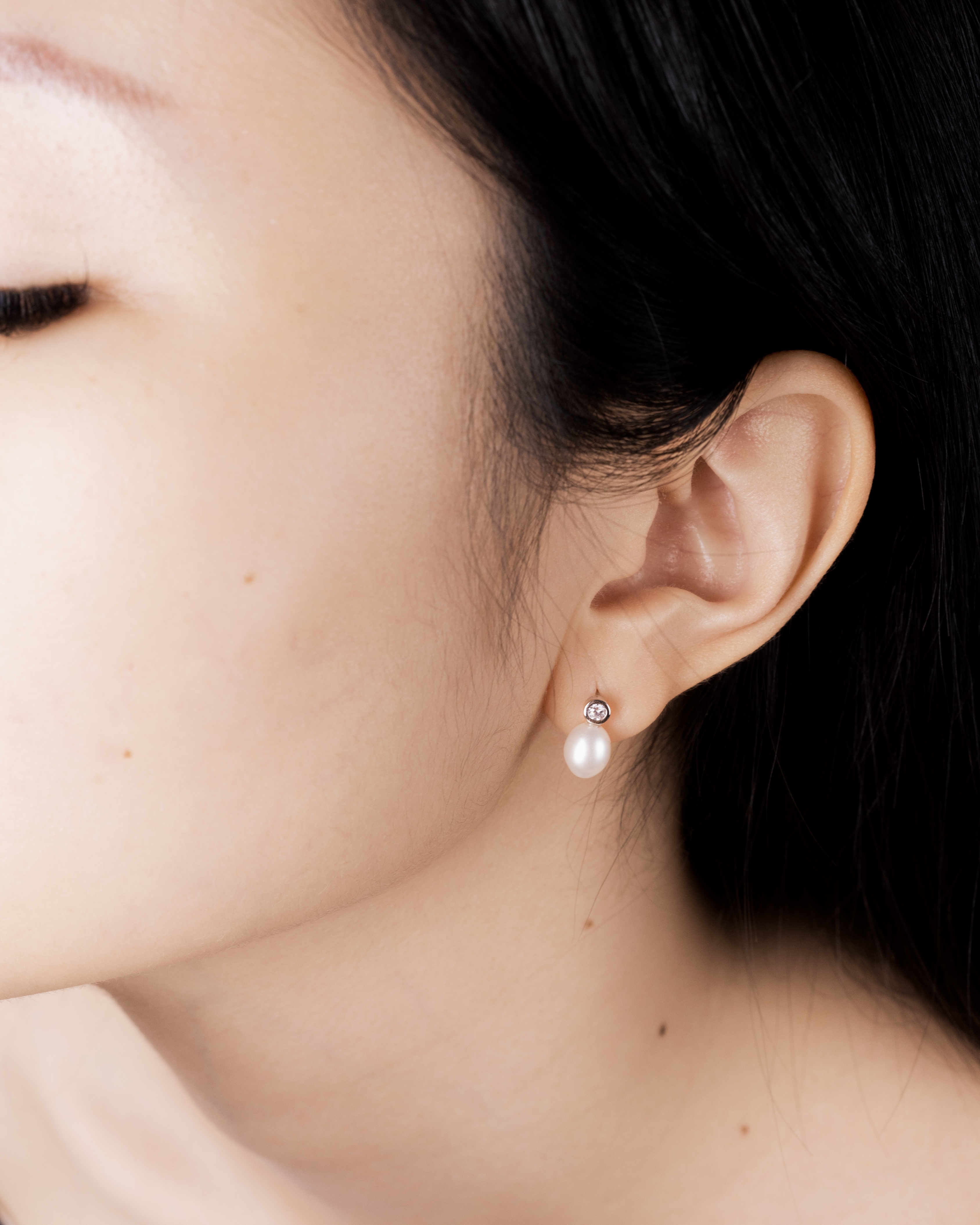 Tsuki pearl drop earring worn on the ear