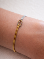 Close-up of centre knot on MNML Unity Bi-Color Snake Chain Bracelet — gold and silver chains intertwined