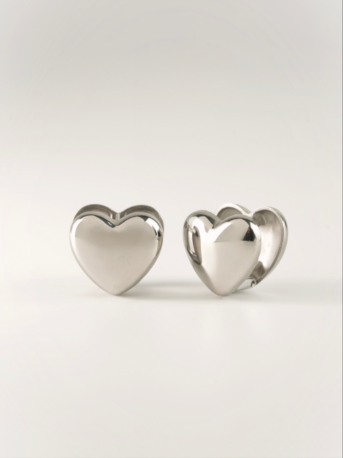 Front-facing view of Venus puffed heart huggie earring