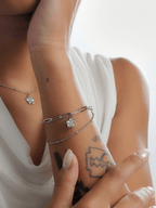 Close-up of bunga raya hibiscus pendant on layered bracelet