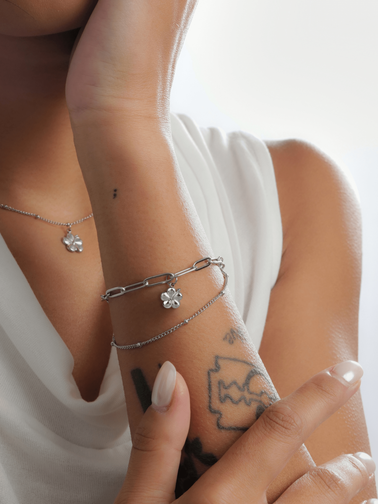 Close-up of bunga raya hibiscus pendant on layered bracelet