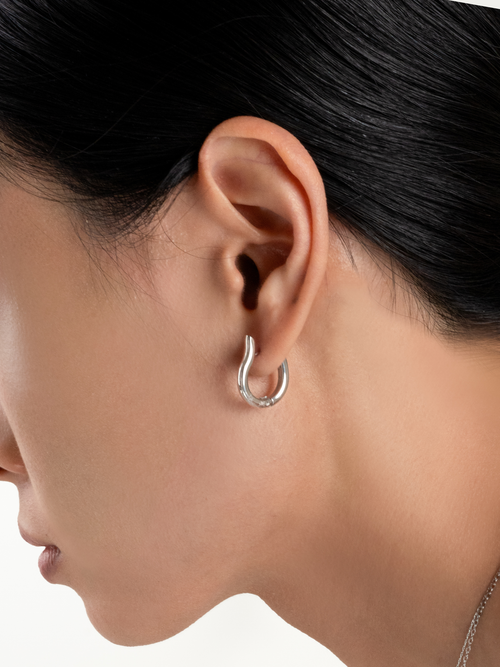 Momentum Hoop Earrings worn on model's ear