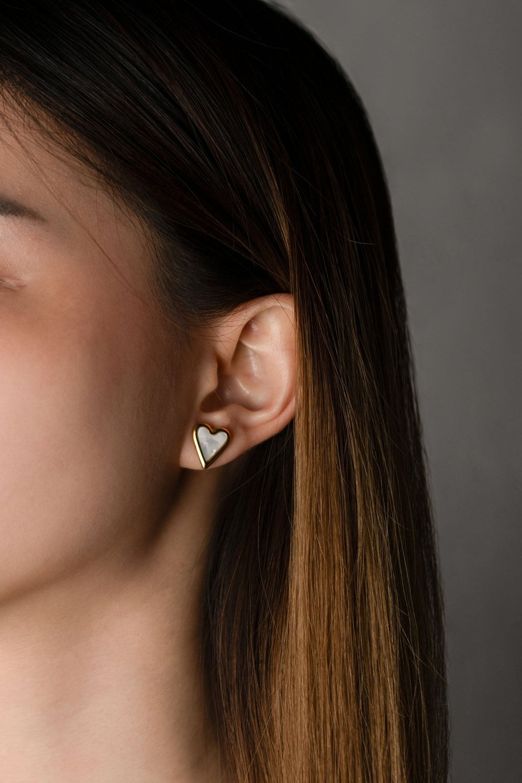 Mother of Pearl Heart Stud Earrings worn on ear, gold heart frame with white shell inlay, MNML Malaysia lifestyle
