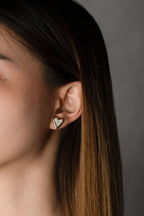 Mother of Pearl Heart Stud Earrings worn on ear, gold heart frame with white shell inlay, MNML Malaysia lifestyle
