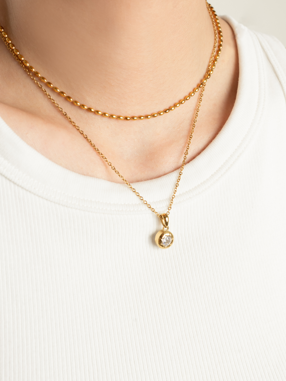 Close-up of bezel-set round brilliant cubic zirconia on Muse Necklace