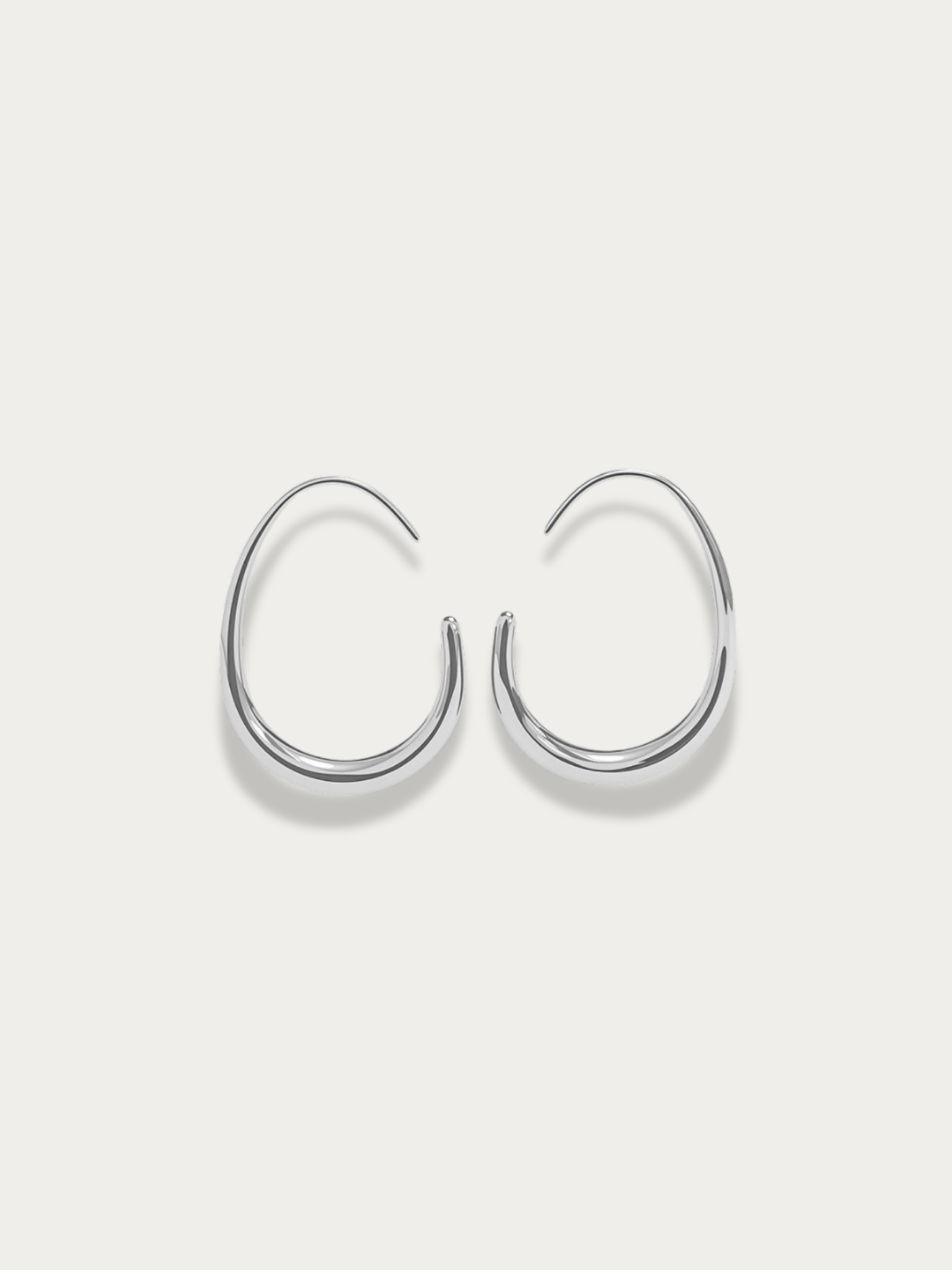 Nova Curve Earrings silver tone titanium, graduated open oval hoop tapering to fine wire tip, product flatlay