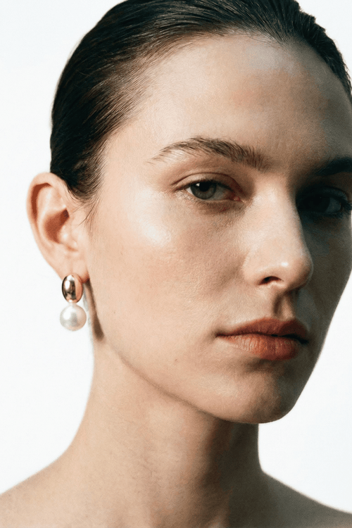 pearl drop earrings worn on ear minimalist style