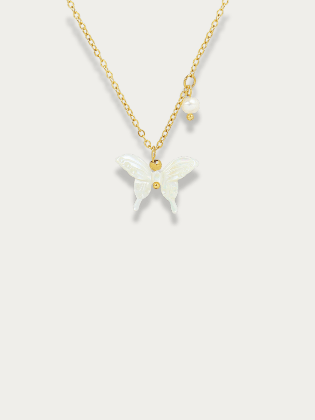 Penny White Butterfly Necklace gold tone titanium, white butterfly pendant with pearl accent, product flatlay