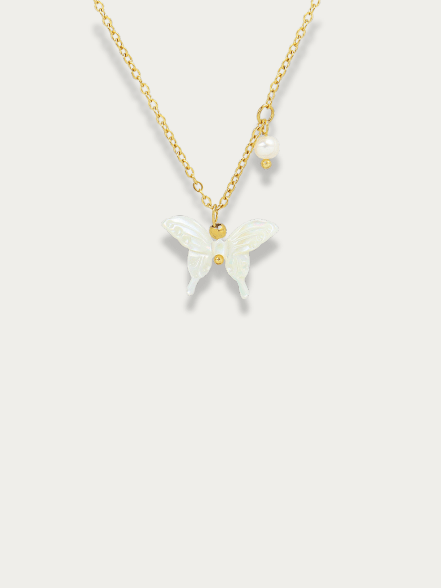 Penny White Butterfly Necklace gold tone titanium, white butterfly pendant with pearl accent, product flatlay