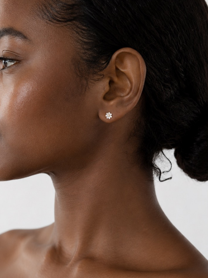 Petite Daisy Stud Earrings in silver worn on model's ear