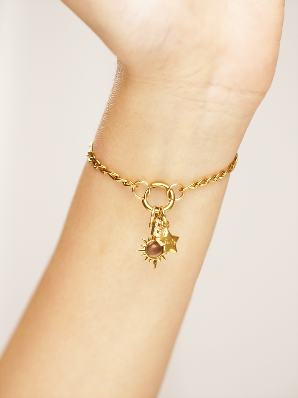 Petite star charm 18K gold plated accessory on wrist