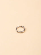 Pioneer Spiral Nose Ring silver tone titanium, spiral wire-wrapped lower arc with smooth upper band, product flatlay