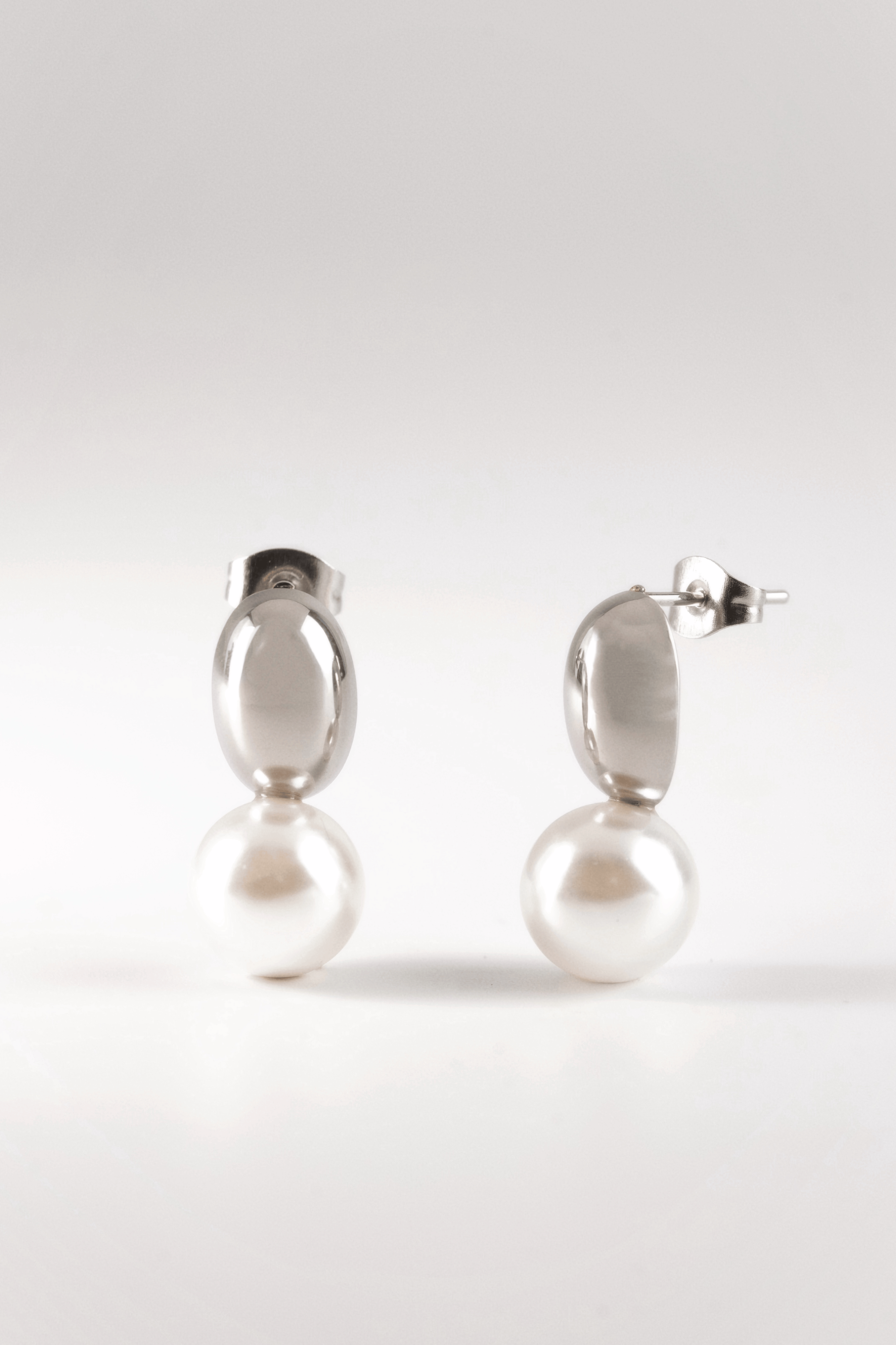 close up pearl drop earrings oval dome design