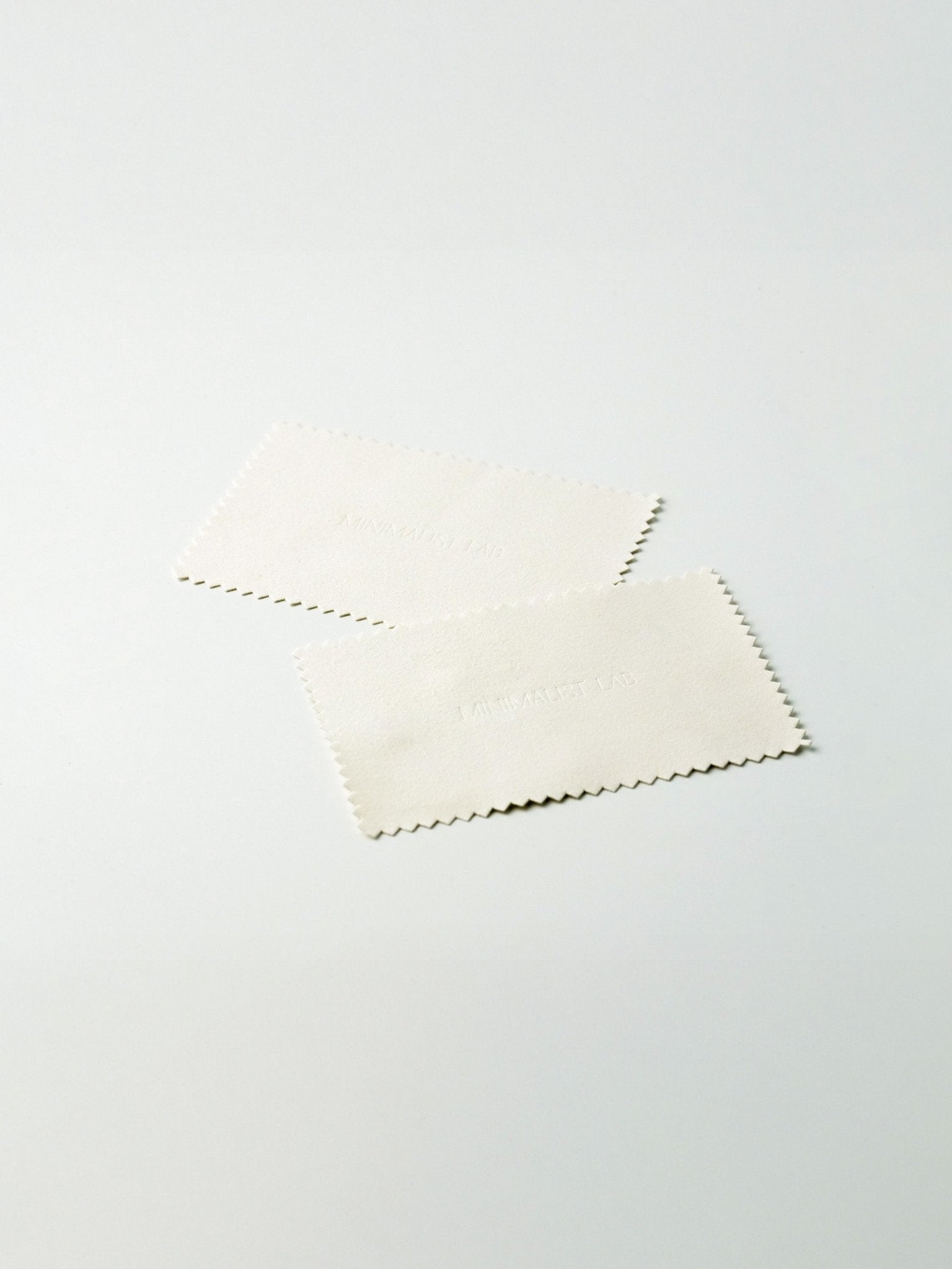 White silver polishing cloth with a subtle pattern on a light gray background