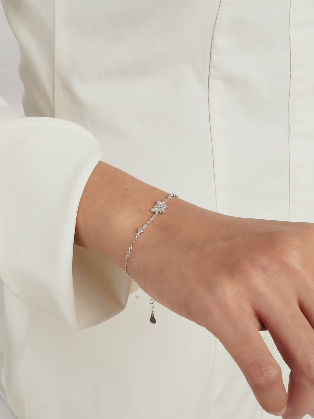 Close-up of Daydreamer CZ Butterfly Charm Bracelet worn on wrist