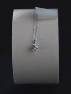 Sawyer solitaire pendant catching light, showing faceting detail