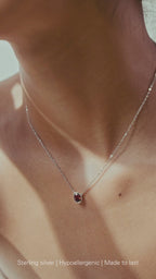 Close-up of sterling silver birthstone on Model