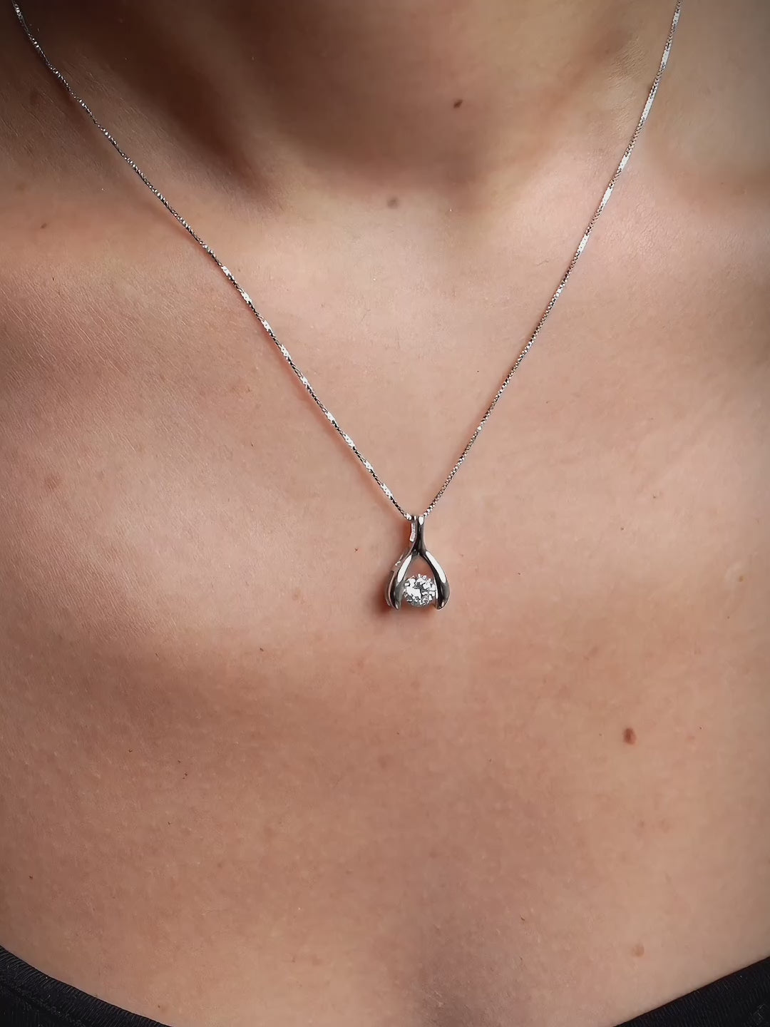 Dianne pendant stone shown dancing within its wishbone frame
