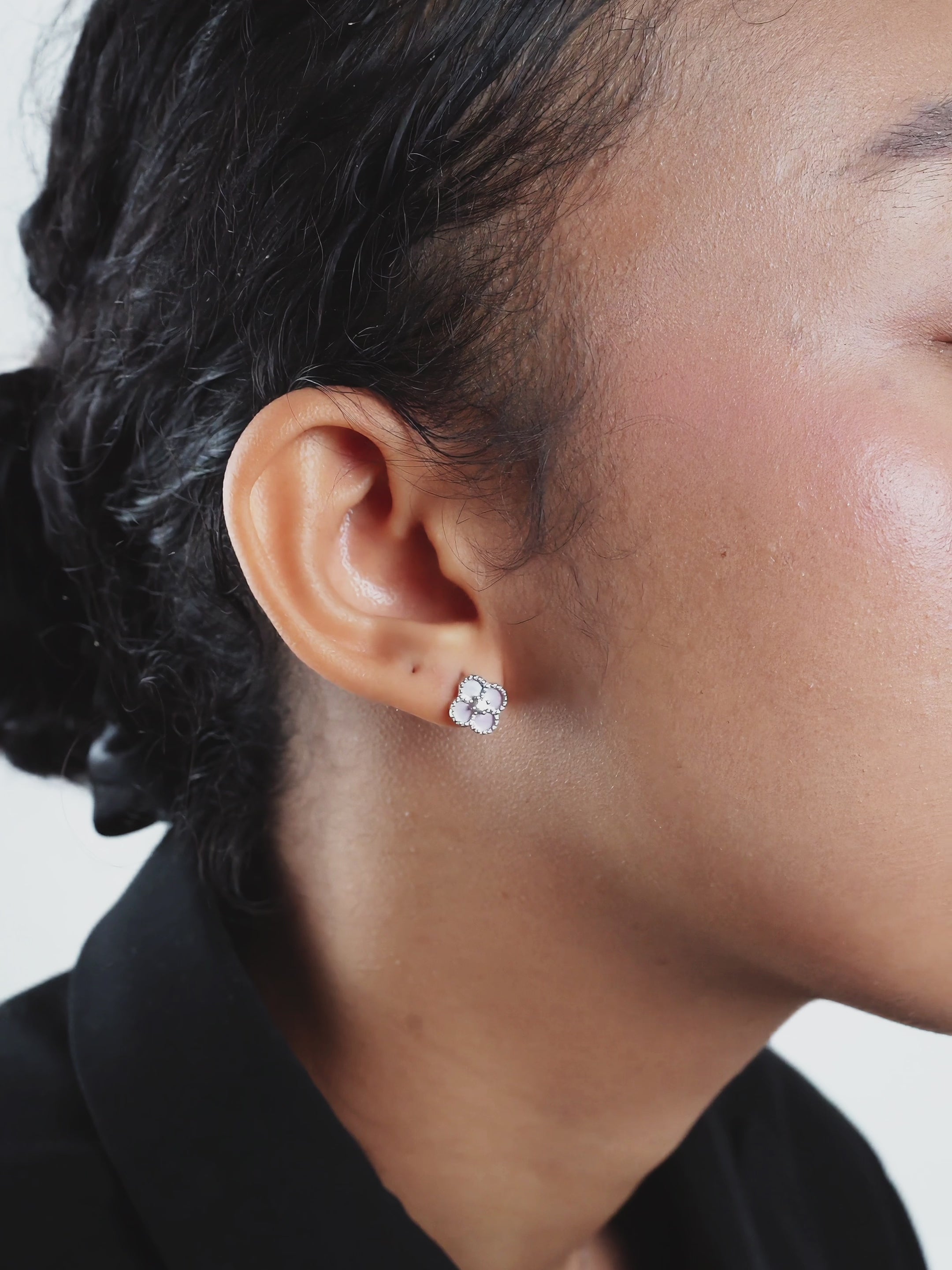 Jolie Clover Stud Earrings worn on model's ear, close-up view 