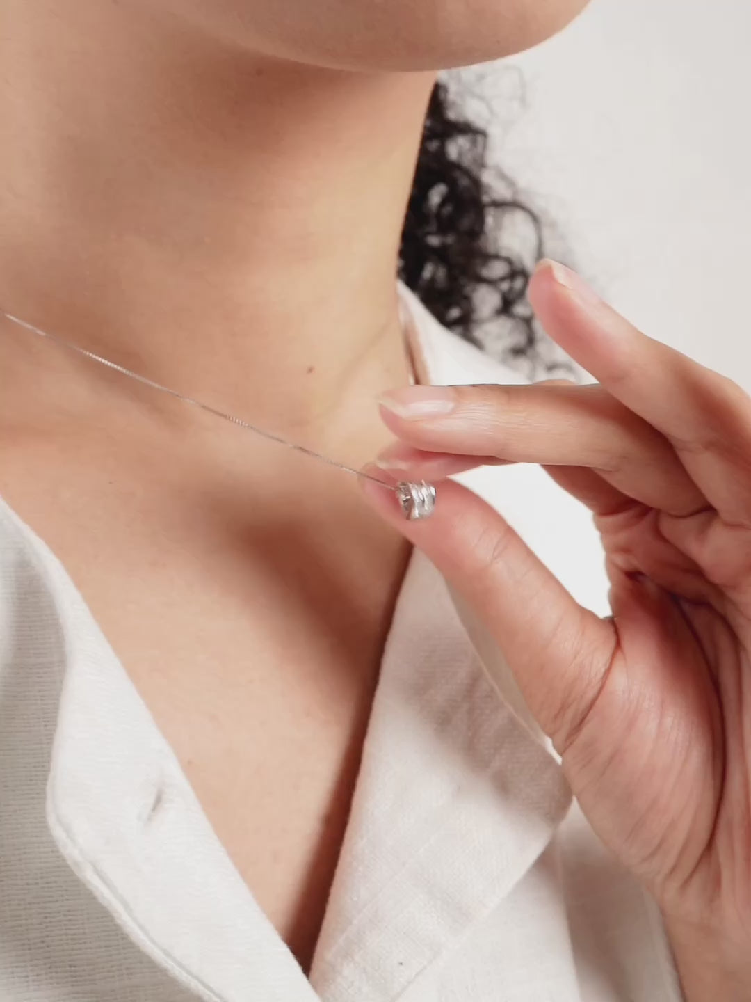 Close-up of channel-set cubic zirconia on Danielle rolling barrel pendant