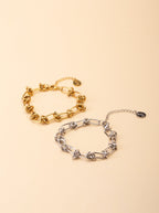 Rebel Knotted Chain Bracelet gold and silver tone stainless steel, bold knotted paperclip chain, product flatlay