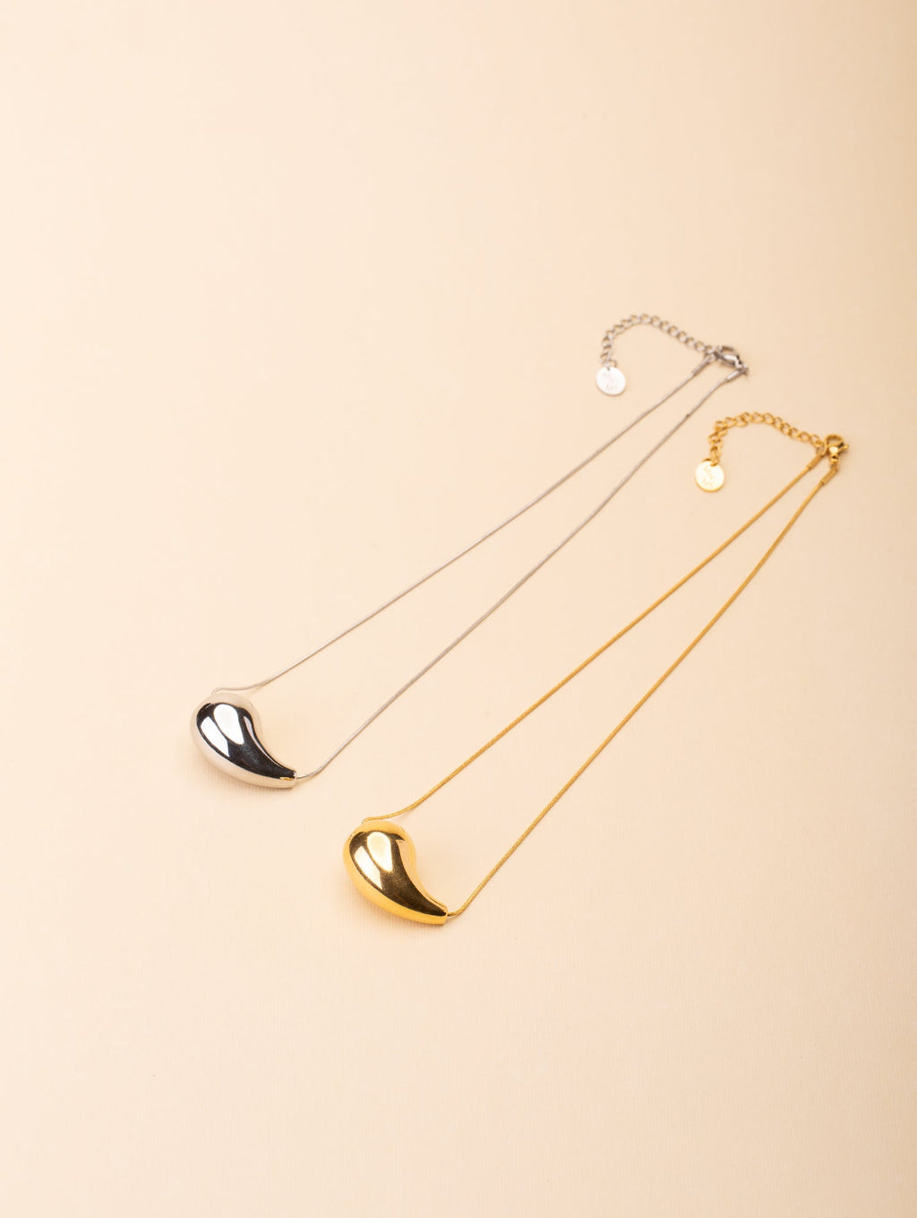Resilience Droplet Necklace gold and silver tone side by side comparison flatlay, MNML Malaysia
