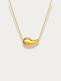 Resilience Droplet Necklace gold tone titanium, large sculptural teardrop pendant on fine snake chain, flatlay