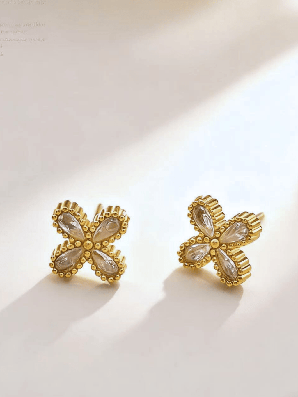Close-up of four pear-cut CZ petal stones on Roselle Floral Stud Earrings, gold titanium