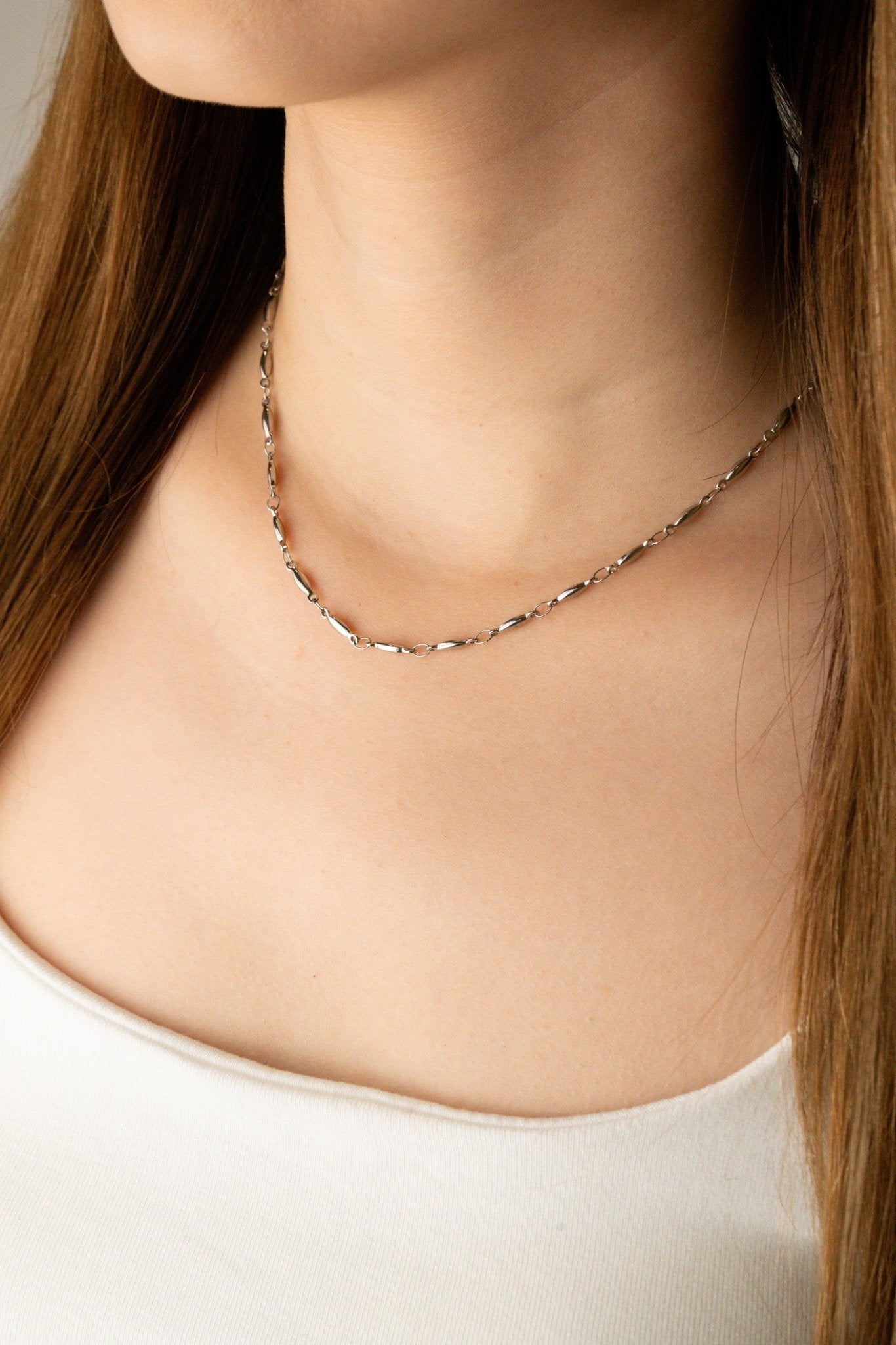Close-up of elongated oval seed links on Seed Chain Necklace, rhodium-plated stainless steel