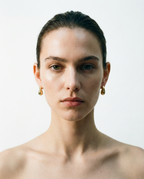 teardrop stud earrings worn on ear minimalist style