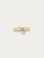 Twist Oval Solitaire Ring gold tone titanium, large oval CZ on twisted rope band, product flatlay