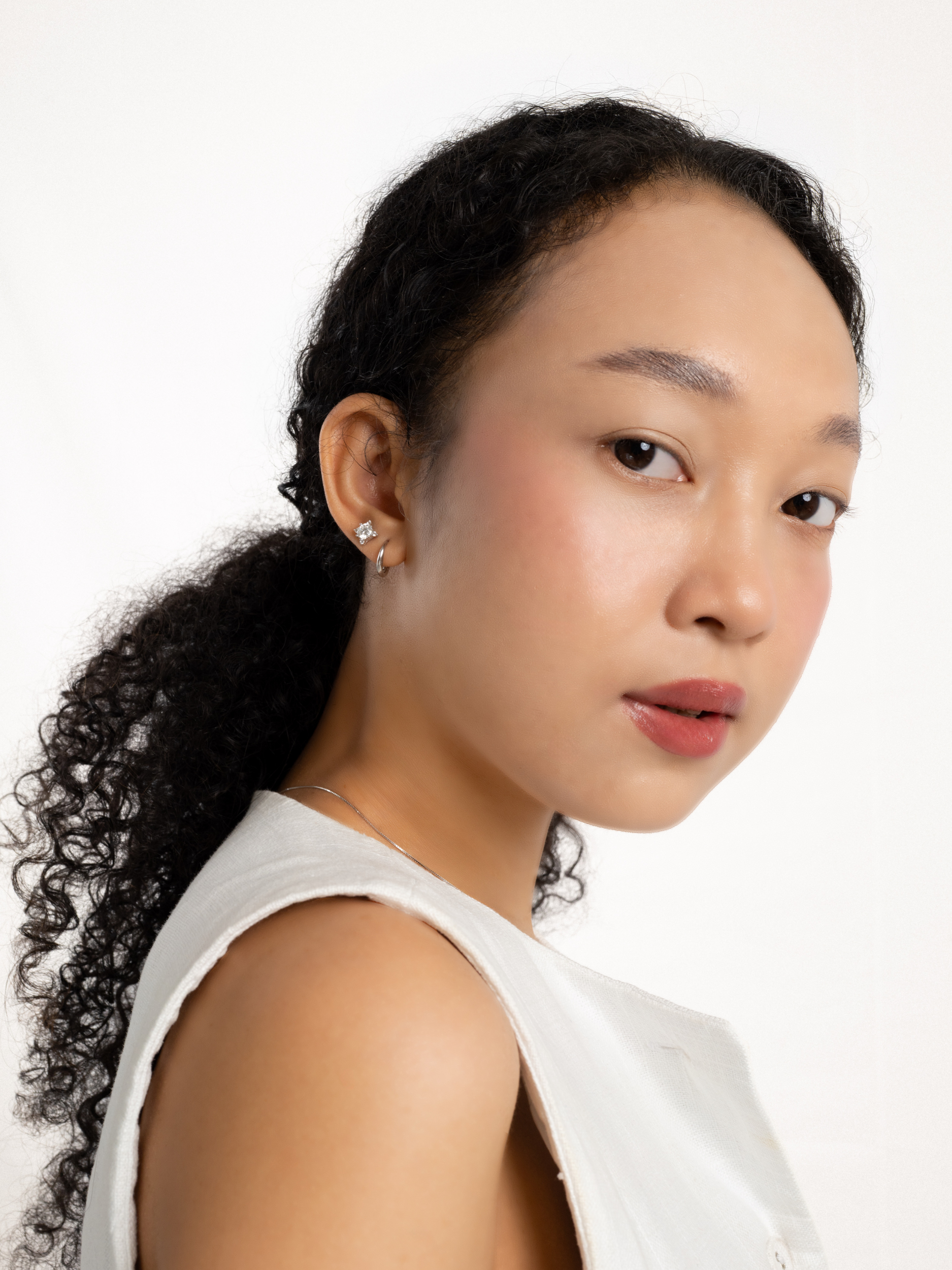 Waroq Wavy Minimalist Hoop Earrings worn on ear