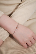 Close-up of fixed knot centrepiece on MNML Knot Bracelet — titanium knot detail