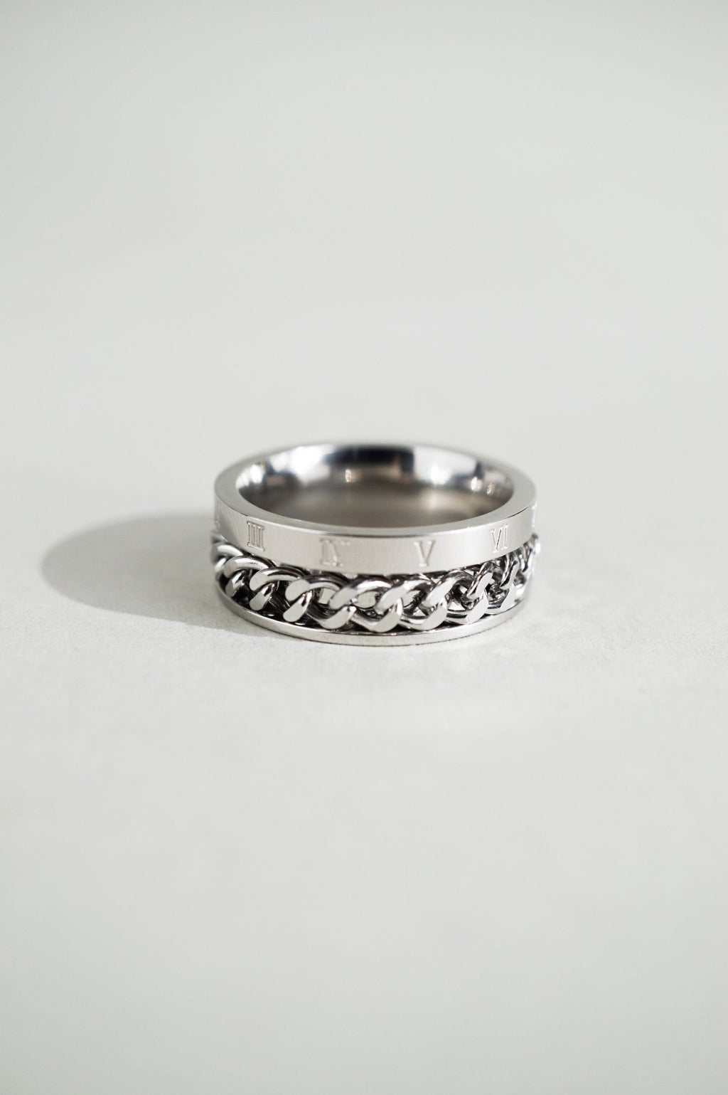 Close-up of Roman numerals engraving on MNML Phoenix Numerals Chain Ring — I II III IV V VI detail