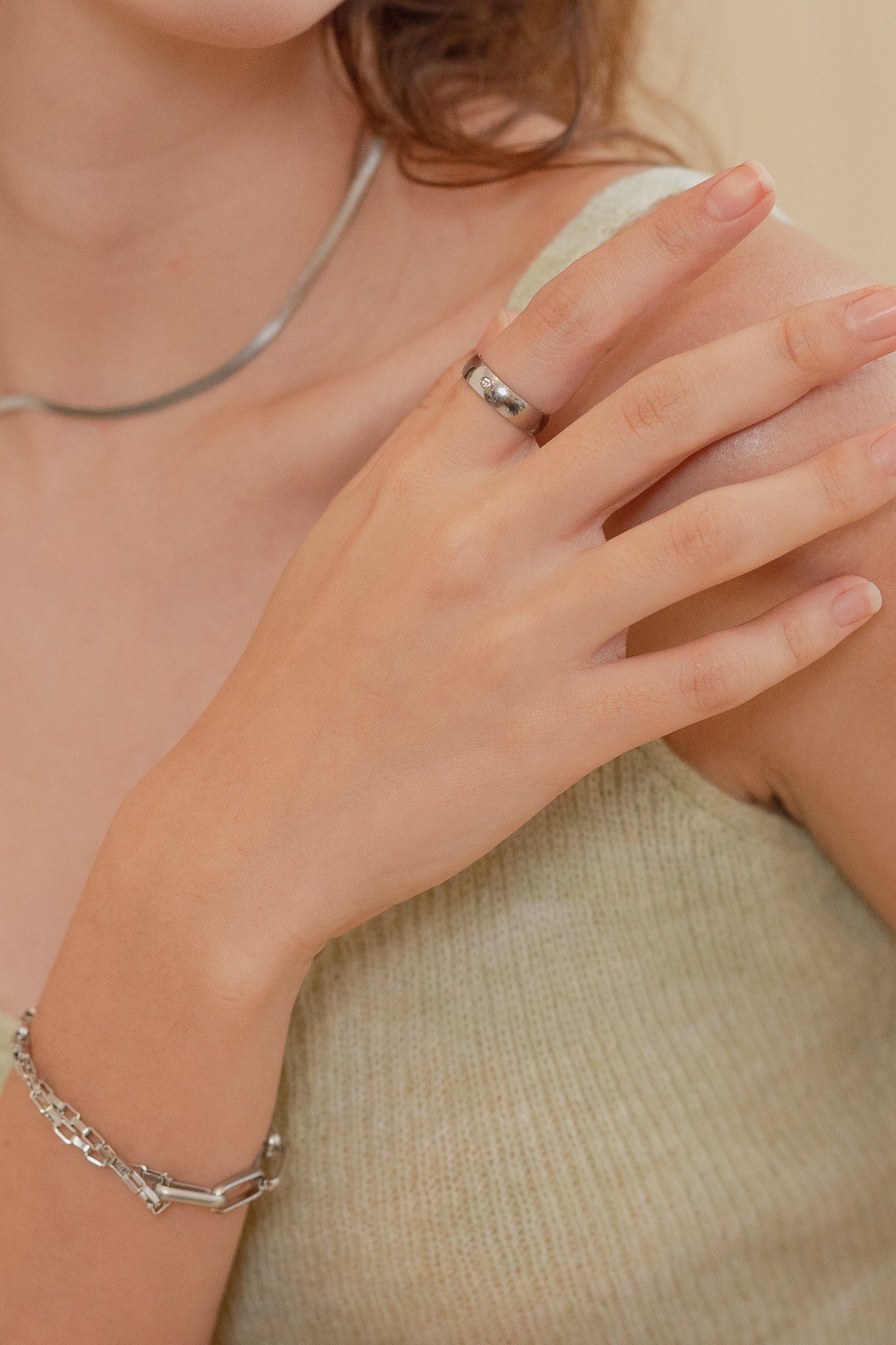 Close-up of single round bezel-set CZ stone on Rae Eternal Diamond Ring, polished stainless steel