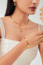 Star Spangled Bangle side profile flatlay showing flat band edge, gold tone stainless steel